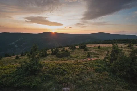 8K Orange sunset over the mountains and trees Video stock 255959608
