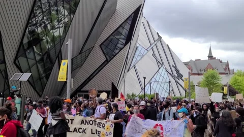 8K - Rally ongoing in front of nice architectural library building in Toronto Video stock 131687109