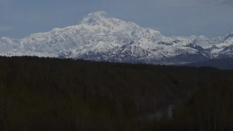 8K real time of wispy spring clouds flowing on a sunny Mount Denali in Alaska Stock Footage 242988754