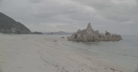 【8K】 A small rocky mountain, Cloudy, Suisyou-hama, beach, Coast, Tsuruga Stock Footage 97254560