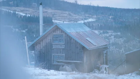 8K Snow-Dusted Mountain Cabin with Young Forest Growth in Background Stock Footage 305846839