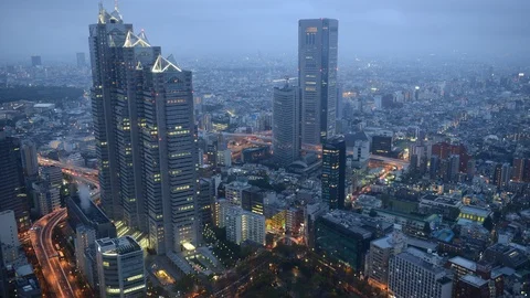 8K Time Lapse Aerial View of Tokyo Skyline Famous Office Buildings Dusk to Night Video stock 104923043