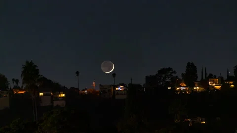 8K Time lapse of crescent moon setting over houses in Los Angeles, California Stock Footage 228501724