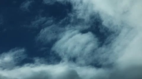 8K Time-Lapse of Ethereal Clouds Moving Right to Left on a Deep Blue Sky Stock Footage 318591946