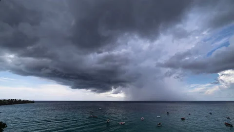 8k time lapse of thundershower scenery with flying clouds over the turquoise sea Stock Footage 162486163