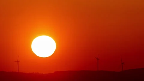 8K time lapse video of sunset over onshore wind turbines Stock Footage 233341202