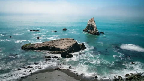 8K Timelapse long exposure shot of sea stack in foggy coastline in Northern Cali Stock Footage 128257733