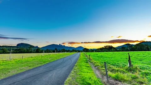 8K Timelapse of Sunset Over Mountains &amp; Country Road Stock Footage 139085270