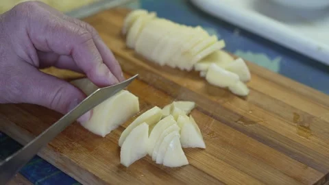 8K Ultra HD Close-up of cutting a raw potato on a wooden board Stock Footage 334605648