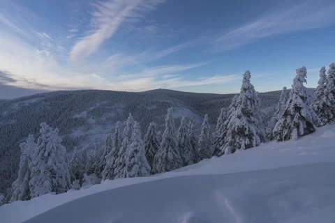 8K Winter lazy clouds rolling over the frozen mountains Video stock 256154780