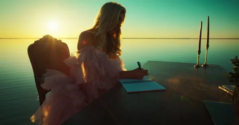 8K • Woman taking notes at desk in the middle of a lake • Slomo Vídeo Stock 284995997