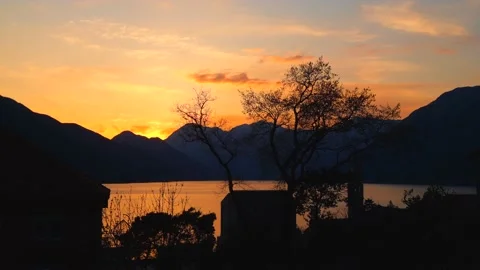 8K Yellow Sunset Over Mountains and Sea Stock Footage 237997916