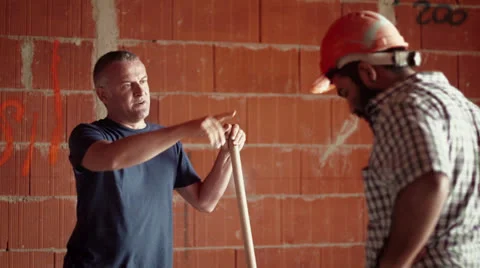 8of11 Men at work in construction site, manual workers Stock Footage 26395208