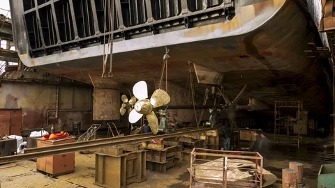 8Workers pull out the propeller from the ship in the dry dock at the shipyard. Stock Footage 86241124