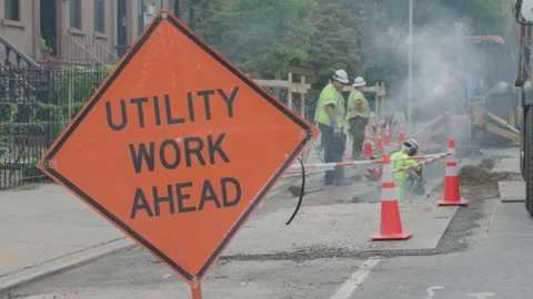9-20-26, Brooklyn, NY, USA - men work on st. to right of Utility Work Ahead sign Stock Footage 346088558