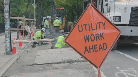 9-20-26, Brooklyn, NY, USA - men work on street to left Utility Work Ahead sign Stock Footage 346088688