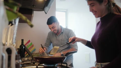 9 Happy Couple Laughing While Cooking In Kitchen At Home Video stock 139403187