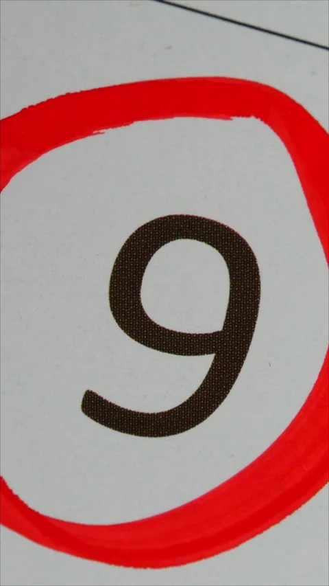 9 - Marking the date in the calendar with a red marker. The ninth day of the mon Stock Footage 283494989