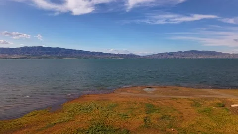 9-Second Aerial Ascent from Country Road to Crystal Blue Lake Stock Footage 339770201