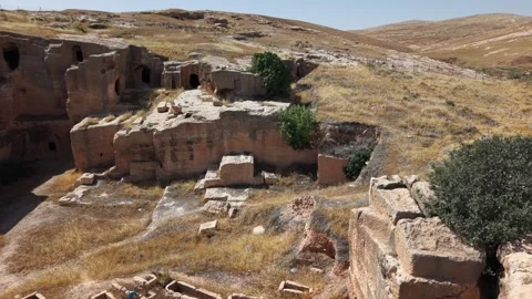9-Second Slow Forward Drone Shot of Ancient Stone Structures and Tombs in Da Stock Footage 334797200