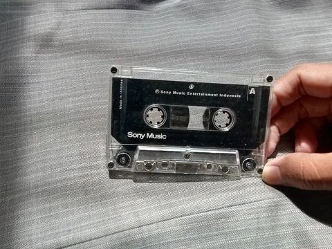 9 September 2022 Central Java, Indonesia: holding a cassette tape, with a cloth Фото