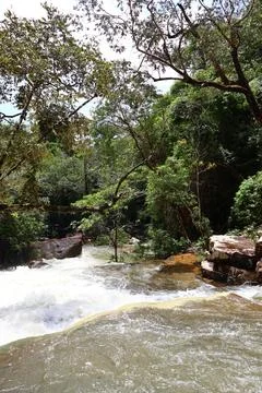 9 Steps Waterfall Flowing Through Lush Tropical Jungle in Kampot, Cambodia Stock Photos