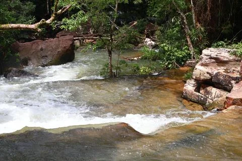 9 Steps Waterfall Flowing Through Lush Tropical Jungle in Kampot, Cambodia Stock Photos