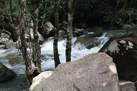 9 Steps Waterfall Flowing Through Lush Tropical Jungle in Kampot, Cambodia Stock Photos