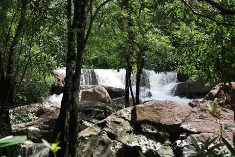 9 Steps Waterfall Flowing Through Lush Tropical Jungle in Kampot, Cambodia Stock Photos