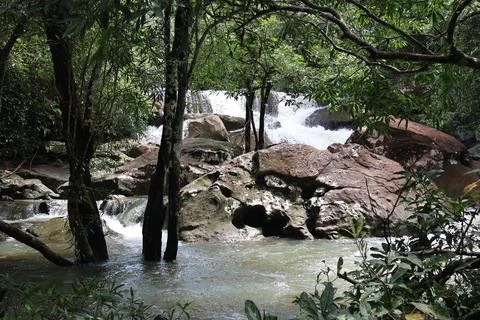 9 Steps Waterfall Flowing Through Lush Tropical Jungle in Kampot, Cambodia Stock Photos