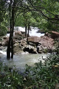 9 Steps Waterfall Flowing Through Lush Tropical Jungle in Kampot, Cambodia Stock Photos