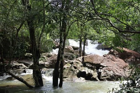 9 Steps Waterfall Flowing Through Lush Tropical Jungle in Kampot, Cambodia Stock Photos
