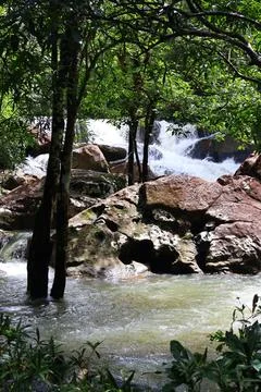 9 Steps Waterfall Flowing Through Lush Tropical Jungle in Kampot, Cambodia Stock Photos