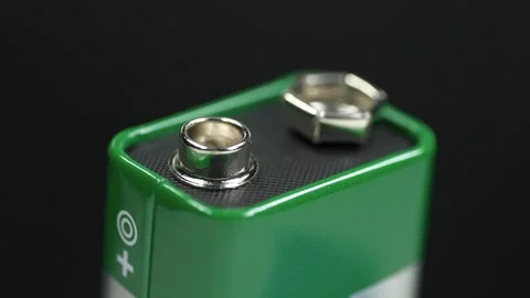 9-volt battery with terminals isolated, green electric battery Stock Footage 333075556
