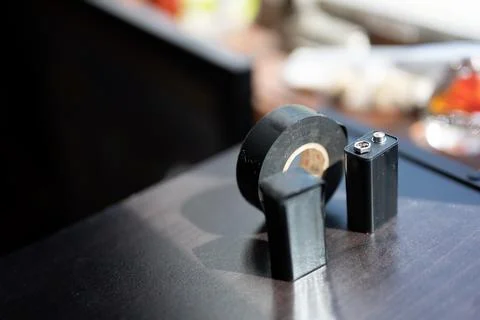9 volt dead battery with terminals covered with electrical tape for safety Foto stock