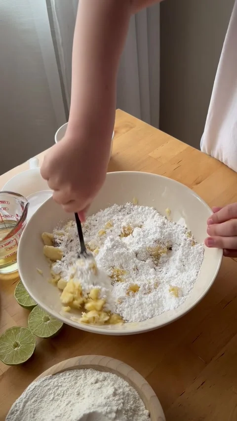 9 years old boy and 1 years baby preparing  a banana cake. Stock Footage 274656578