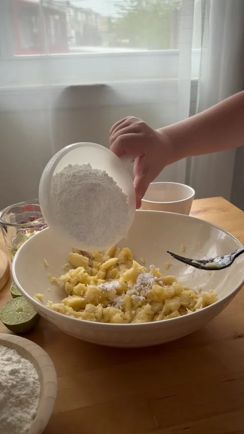 9 years old boy and 1 years baby preparing  a banana cake. Stock Footage 274656581