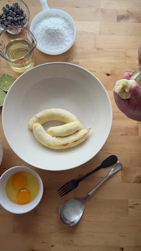 9 years old boy and 1 years baby preparing  a banana cake. Stock Footage 274656590