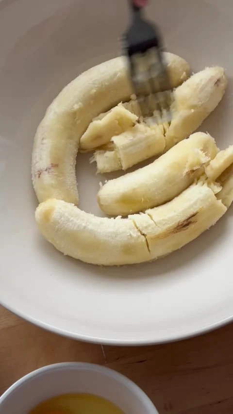 9 years old boy and 1 years baby preparing  a banana cake. Stock Footage 274656592