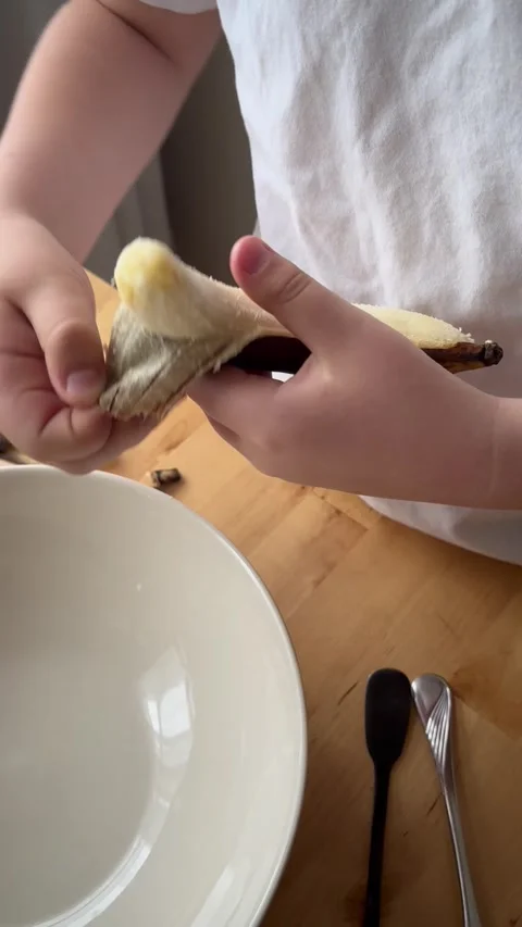 9 years old boy and 1 years baby preparing  a banana cake. Stock Footage 274656597