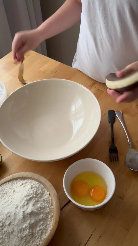 9 years old boy and 1 years baby preparing  a banana cake. Stock Footage 274656600