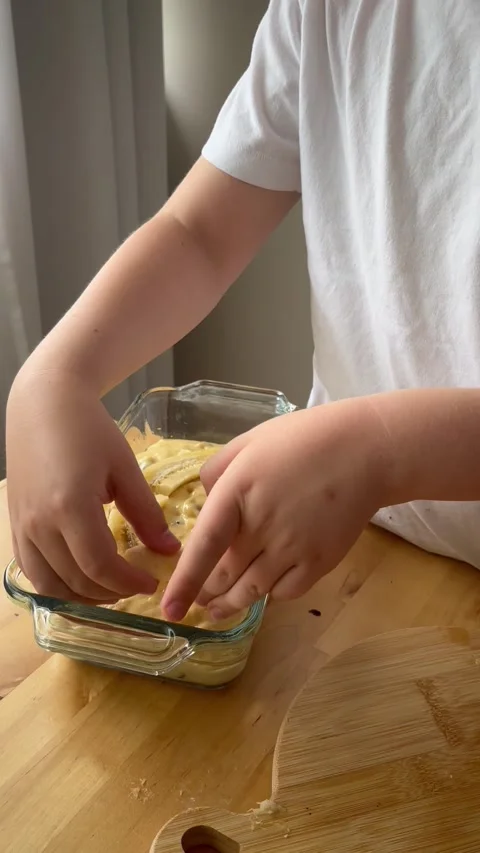 9 years old boy preparing  a banana cake. kids cooking step by step Stock Footage 274656476