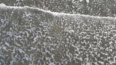 90 Degree Drone Down Shot of Waves Rippling In on Beach Stock-Footage 276198993