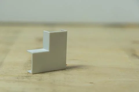 90 degree elbow type electrical connector on wooden background Stock Photos