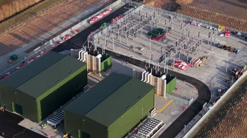 90 degree overhead drone shot of industrial metal busbars pylons transformers Stock Footage 336322940