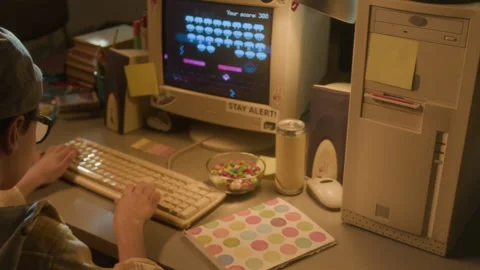 90s Boy Inserting Floppy Disc into Computer Stock Footage 304861102