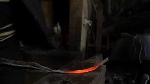 9/10 Blacksmith Forging Hits Metal Iron with Hummer In Workshop Stock Footage 233995711