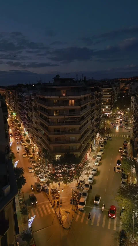 916 drone video tilting down to a top view of city traffic at night in Thess Stock-Footage 346990322
