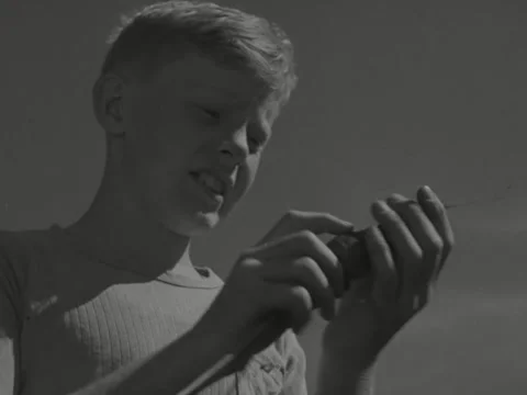 9/26/1946: Boy examines freshly-dig vegetable Stock Footage 231338053