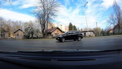 943-03 Car Ride Dashboard Center View Exiting Parking Lot Onto Main Street Stock Footage 105664642